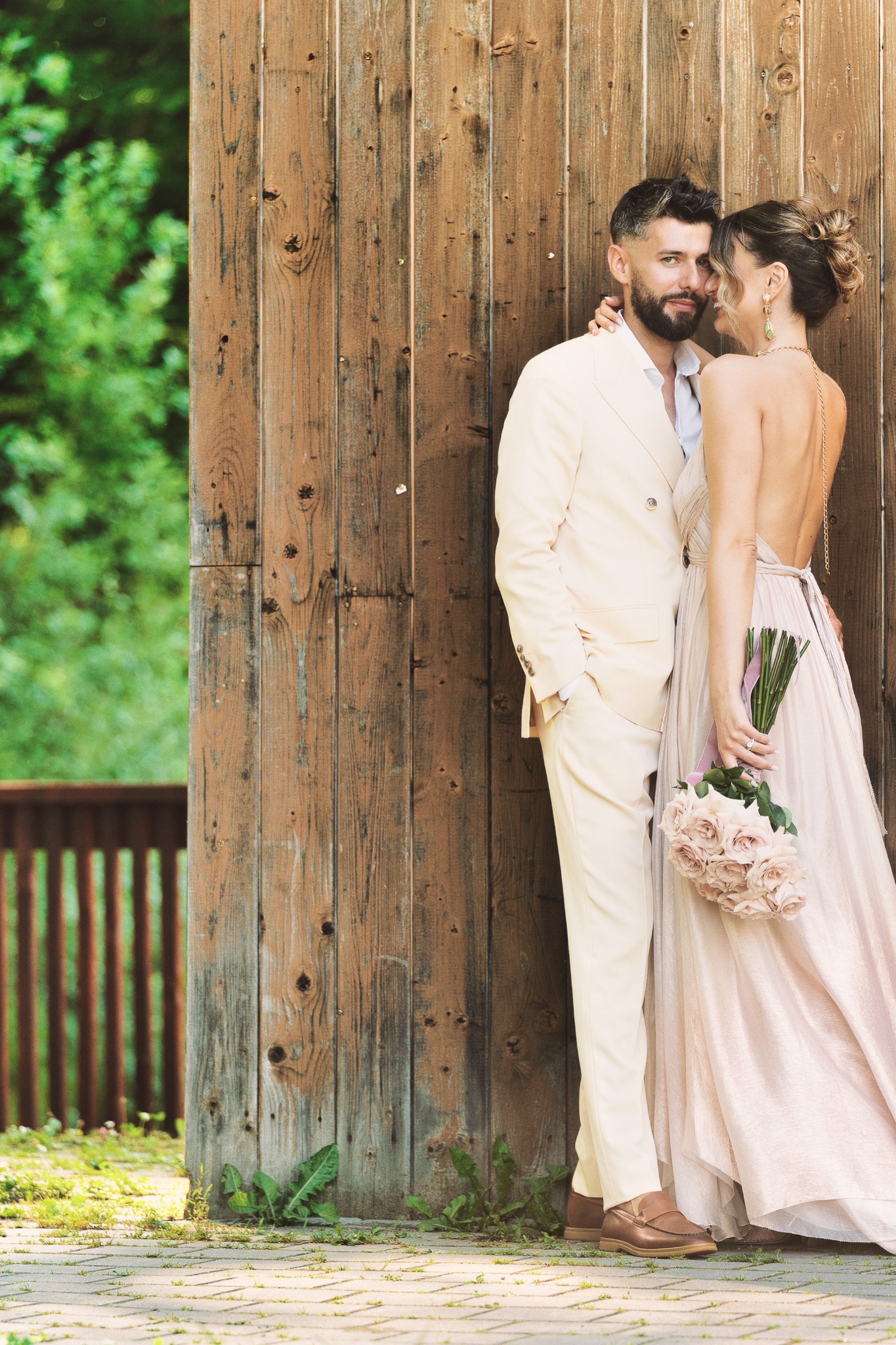 Couple beside a wooden architectural structure, photographed by Cristian Muntean
