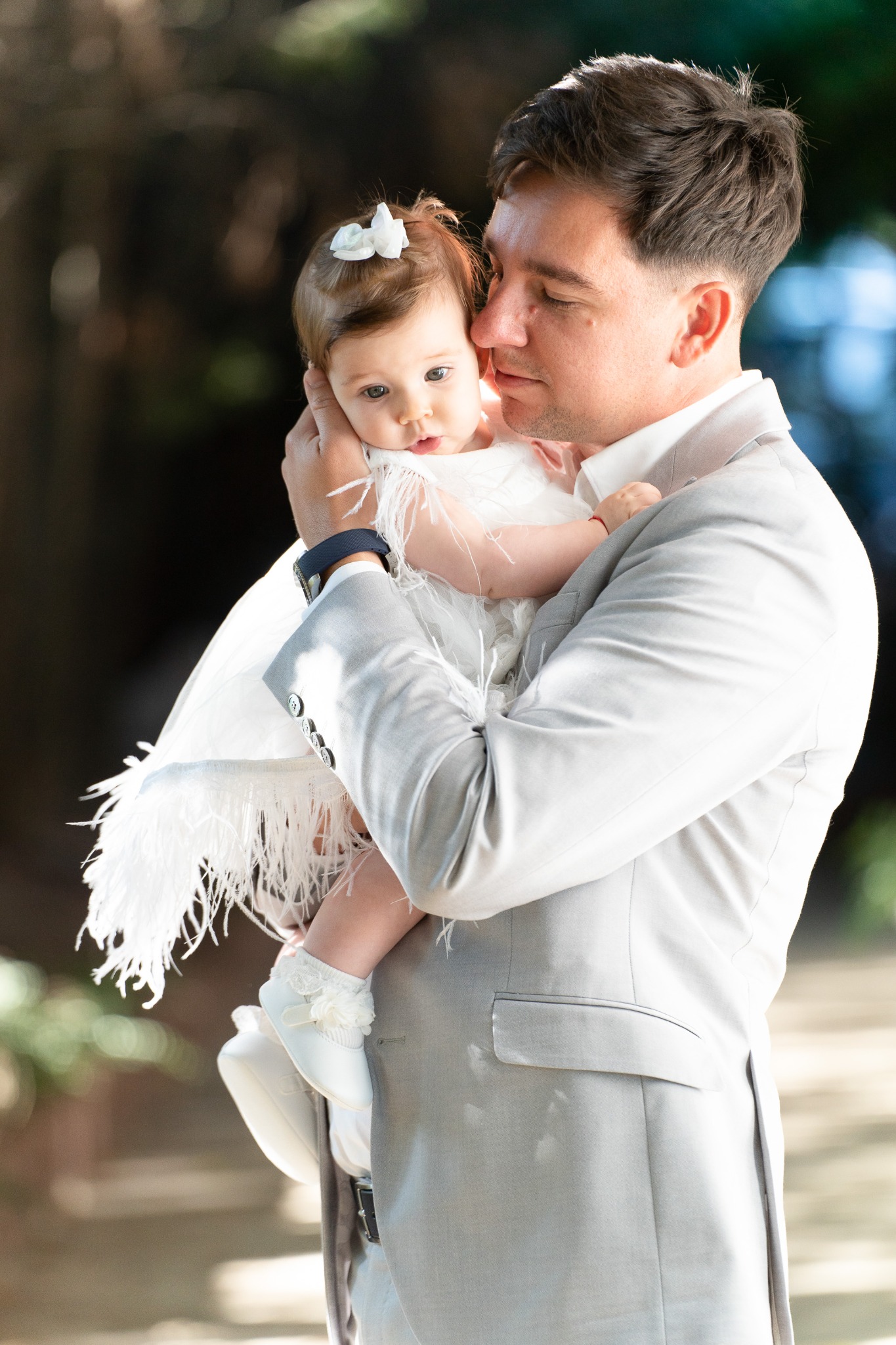 Father holding his daughter outdoors